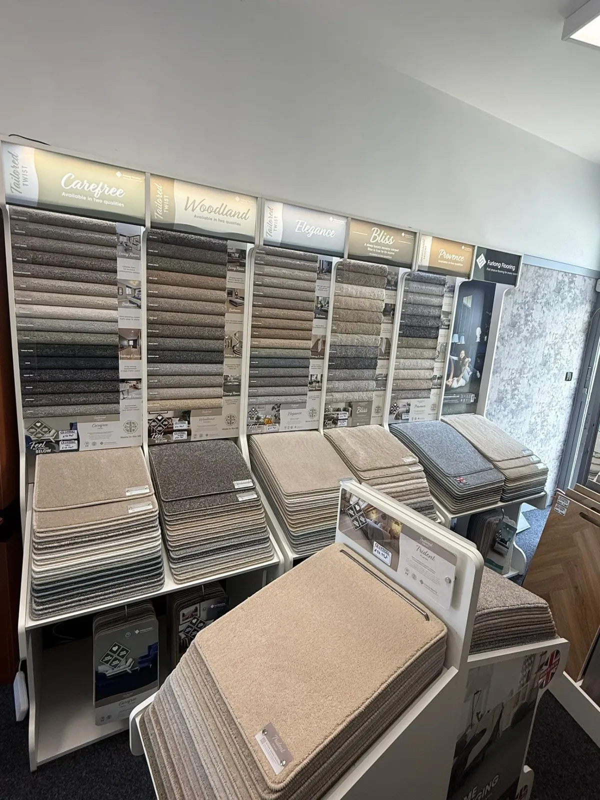 Wall of carpet sample ranges in the CR Carpets and Flooring showroom